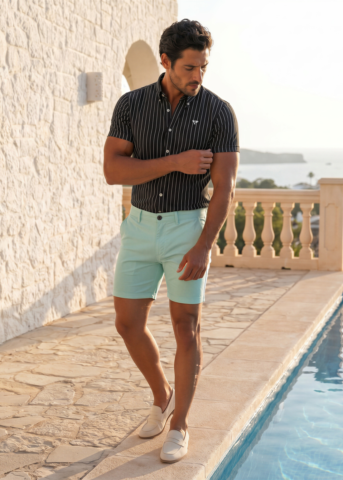 Man wearing Capri Chino Shorts in Reef blue with a short sleeve shirt in warm humid weather