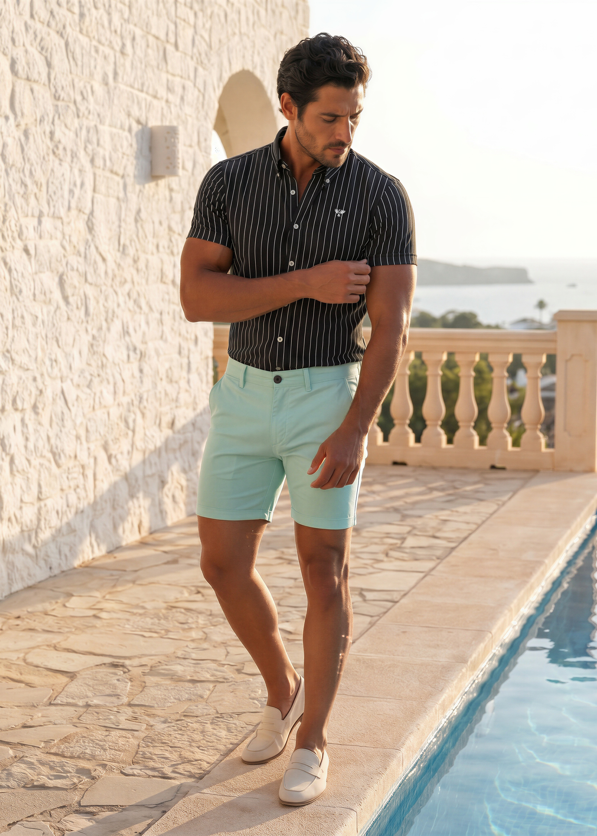 Man wearing Capri Chino Shorts in Reef blue with a short sleeve shirt in warm humid weather