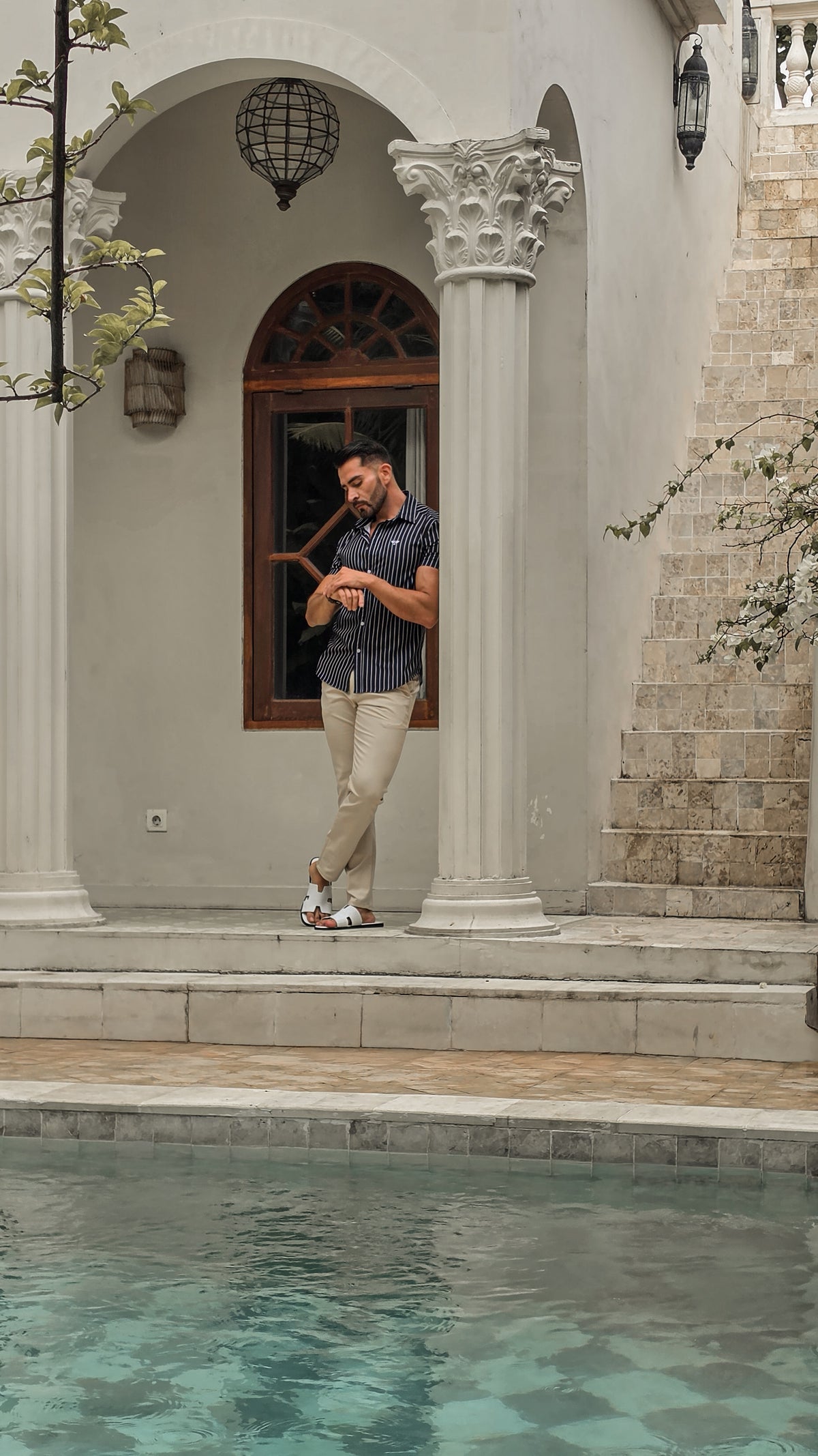The Milano pinstripe shirt by a villa pool, part of the Summer Wardrobe prize