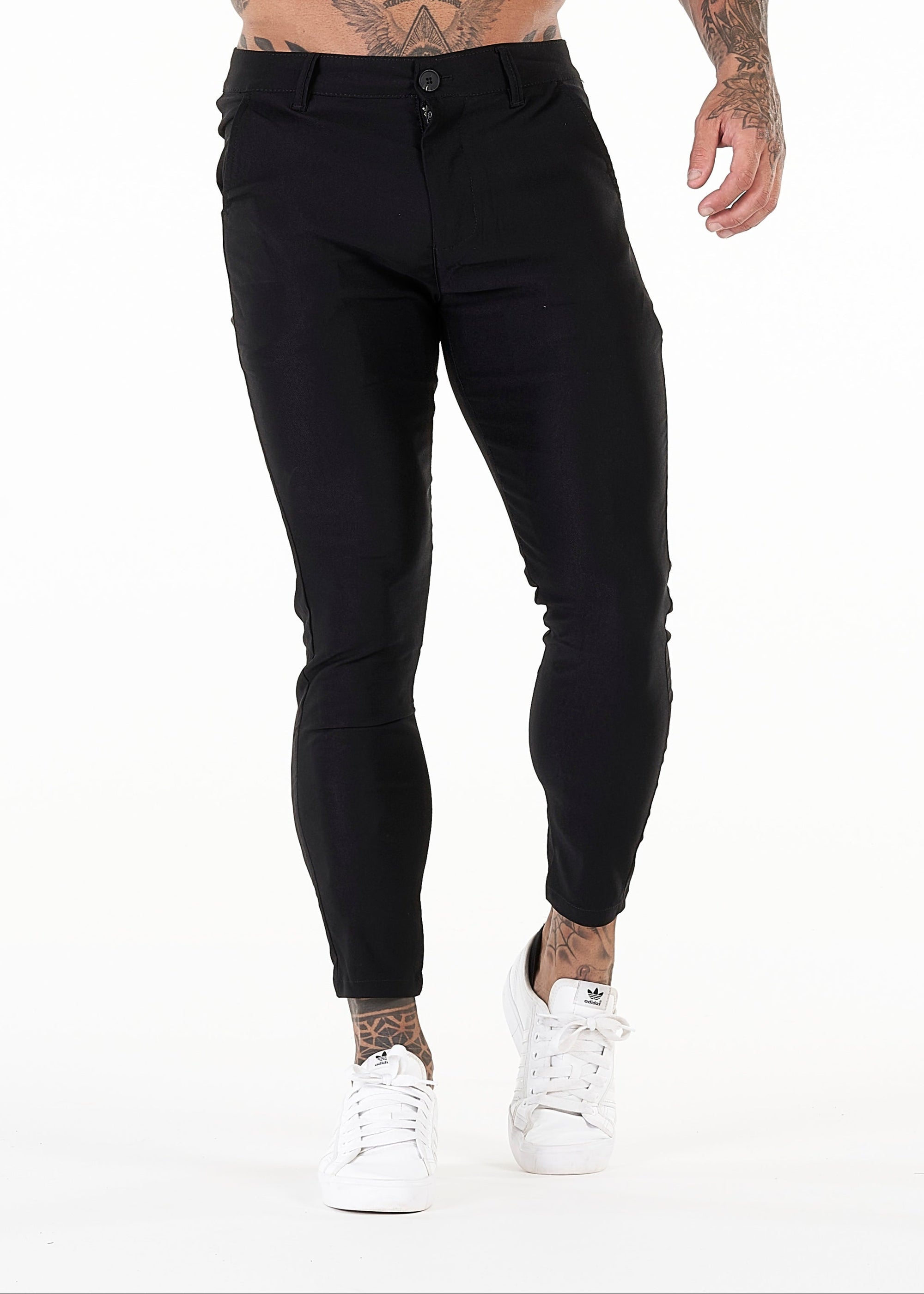 Person wearing black pants on a white background