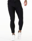 Person wearing black pants on a white background